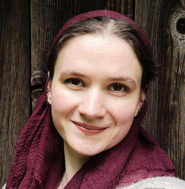A head shot of the editor, Zoe, smiling at the camera